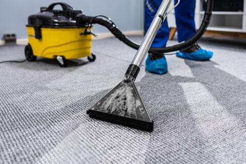 Carpet extraction cleaning tool deep-cleaning an office carpet during commercial cleaning