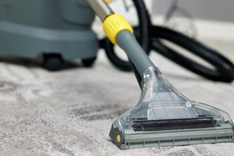 Commercial carpet cleaning machine deep cleaning an office carpet